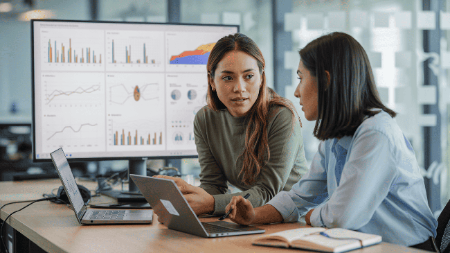 Analistas de datos trabajando con dashboards y visualización de datos en Tableau en entorno profesional.